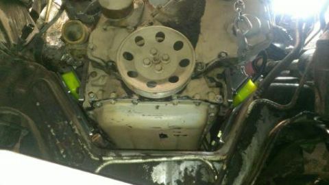1996 Ford Bronco - Close-up view of an engine's internal components, including a pulley and bright yellow hoses.