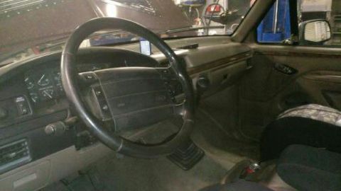 1996 Ford Bronco - The interior of a vehicle is shown, with a focus on the steering wheel and dashboard area.
