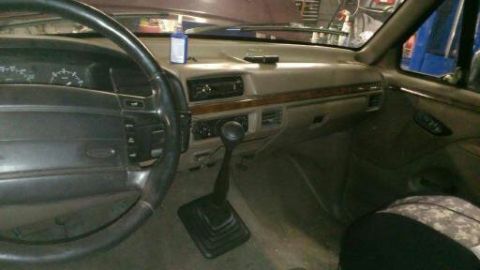 1996 Ford Bronco - The interior of a 1990s Ford truck, a dashboard and steering wheel.
