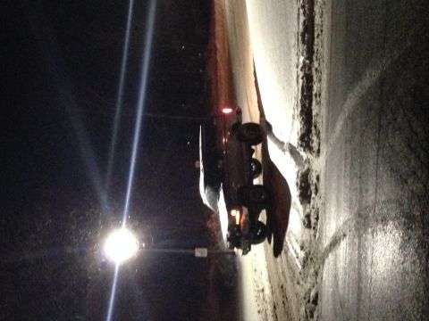 1995 Ford Bronco - 1995 Ford Bronco seen parked on a snow-covered road during nighttime hours.
