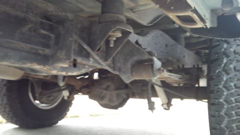 1992 Ford Bronco - Close-up view of the undercarriage, focusing on the suspension components and differential.