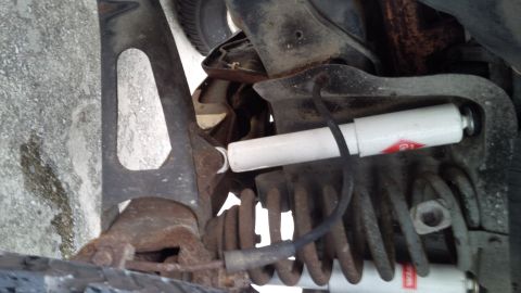 1992 Ford Bronco - Undercarriage view shows suspension parts including a shock absorber and spring.
