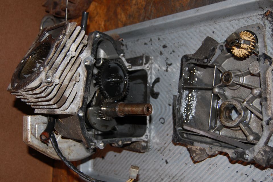 Disassembled engine block with visible gears and crankshaft