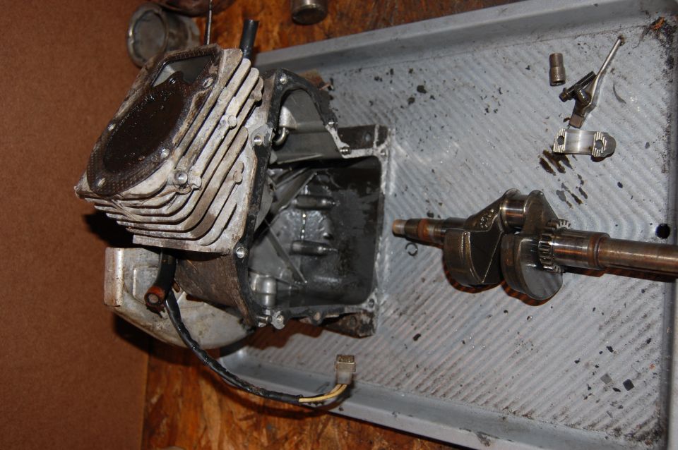 Engine block and crankshaft disassembled in a tray