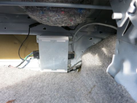 1991 Ford Crown Victoria LTD - Close-up view of the underside of a car seat, revealing electrical components and insulation.