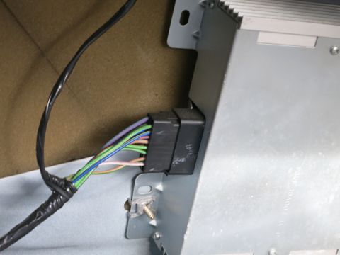 1991 Ford Crown Victoria LTD - Close-up view of a vehicle's wiring harness connected to a car stereo, showing multiple colored wires.