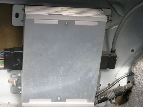 1991 Ford Crown Victoria LTD - A car amplifier is visible, mounted within the interior of a vehicle, with visible wiring and connectors.