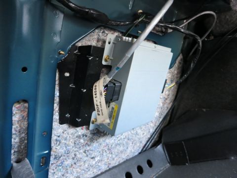 1991 Ford LTD Crown Victoria - Close-up of a car's electronic module and wiring harness, showing part number and date code.