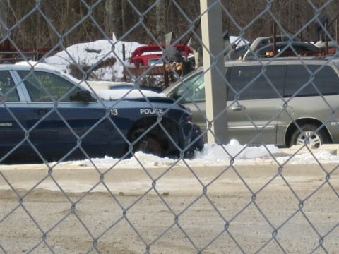 1991 Ford LTD Crown Victoria - A damaged police car sits in the snow, with other vehicles and debris in the background.