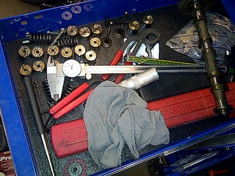 1995 Ford Probe - A collection of engine components and tools are organized within a blue toolbox drawer.