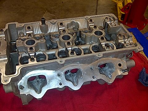 1995 Ford Probe - Close-up view of an engine cylinder head, showing the intake ports and valve train components.