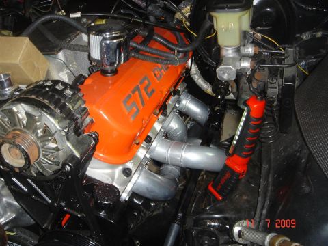 1990 Chevrolet Silverado 1500 - The engine features orange valve covers with "572 Big Block" lettering and custom exhaust headers.
