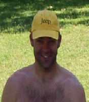 1994 Ford Bronco - A man smiles while wearing a yellow hat with the Jeep logo visible.