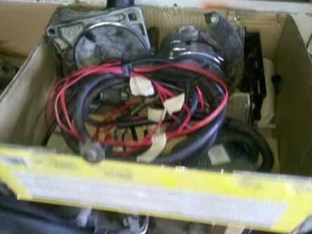 1982 Ford Bronco - A box contains various engine components and a bundled wiring harness with red and black wires.