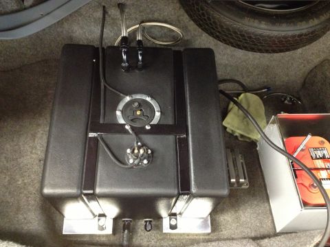 1992 Ford Crown Victoria - Aftermarket fuel cell installed in the trunk of a vehicle, with visible plumbing and a spare tire.