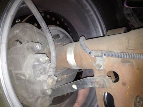 1992 Ford Crown Victoria - Close-up view of the rear axle and brake assembly, showing details of the suspension and braking components.