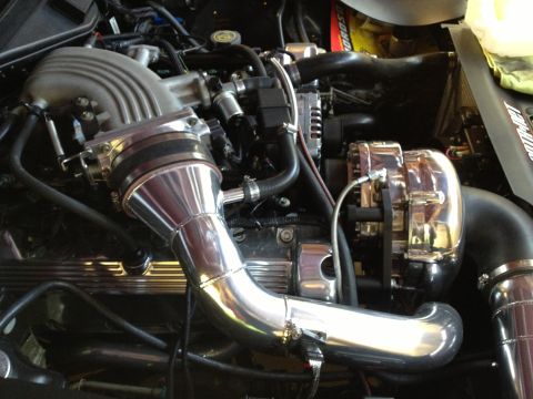 1992 Ford Crown Victoria - Close-up of a modified engine bay, highlighting a polished supercharger and intake system.