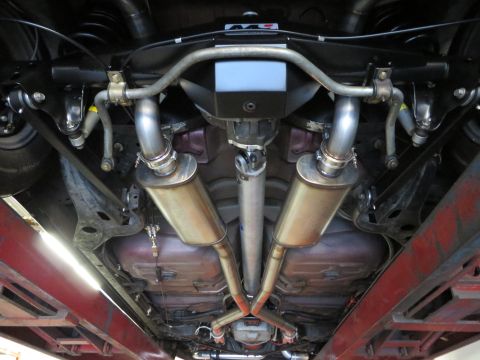 1992 Ford Crown Victoria - Underside view of a car's exhaust system with dual mufflers and driveshaft.