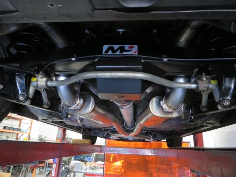 1992 Ford Crown Victoria - The underside of a vehicle is shown, highlighting a custom dual exhaust system with visible M9 branding.