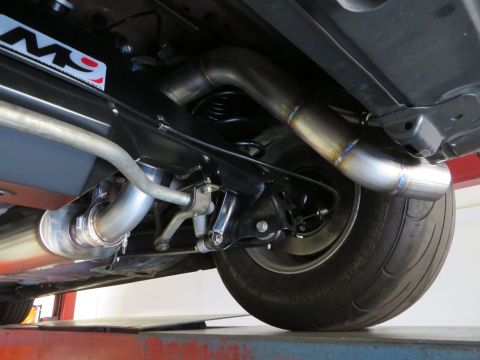 1992 Ford Crown Victoria - Close-up of a vehicle's custom exhaust and suspension components, with a "M9" decal on the frame.