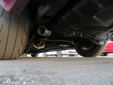 1992 Ford Crown Victoria - Close-up of a car's undercarriage, focusing on the exhaust system and rear tire.