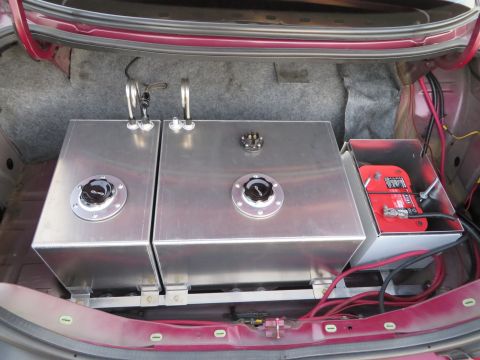 1992 Ford Crown Victoria - Custom fuel tank and battery setup installed in the trunk of a vehicle.