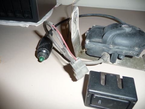 1993 Mazda MX-3 - Collection of automotive electrical components, possibly for a power antenna or similar system.