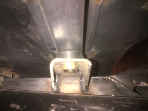 1985 Jeep CJ7 - Close-up view of a custom underbody frame mount with a rubber bushing and metal bracket.