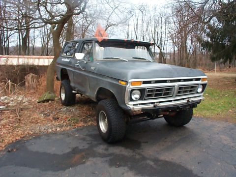 1979 Ford Bronco - This lifted 1978 Ford Bronco is parked on an asphalt driveway with trees in the background.