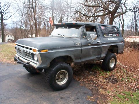 1979 Ford Bronco - This lifted 1979 Ford Bronco is shown in a three-quarter front view, parked outdoors on a slightly uneven surface.