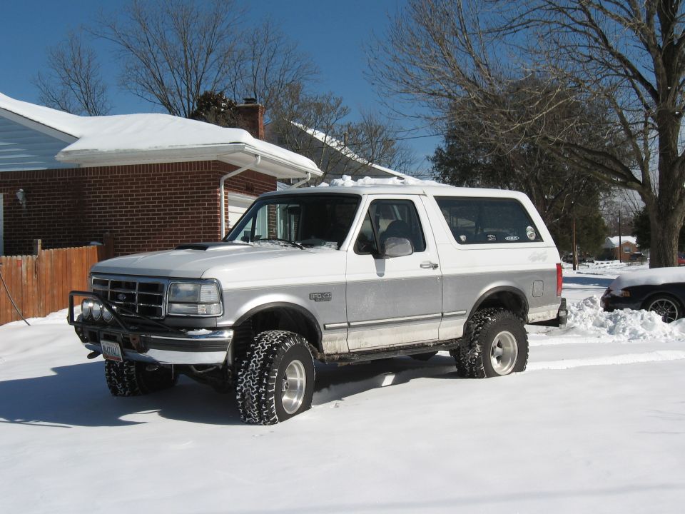 1994 Ford Bronco parked in snow, front bull bar, two-tone paint