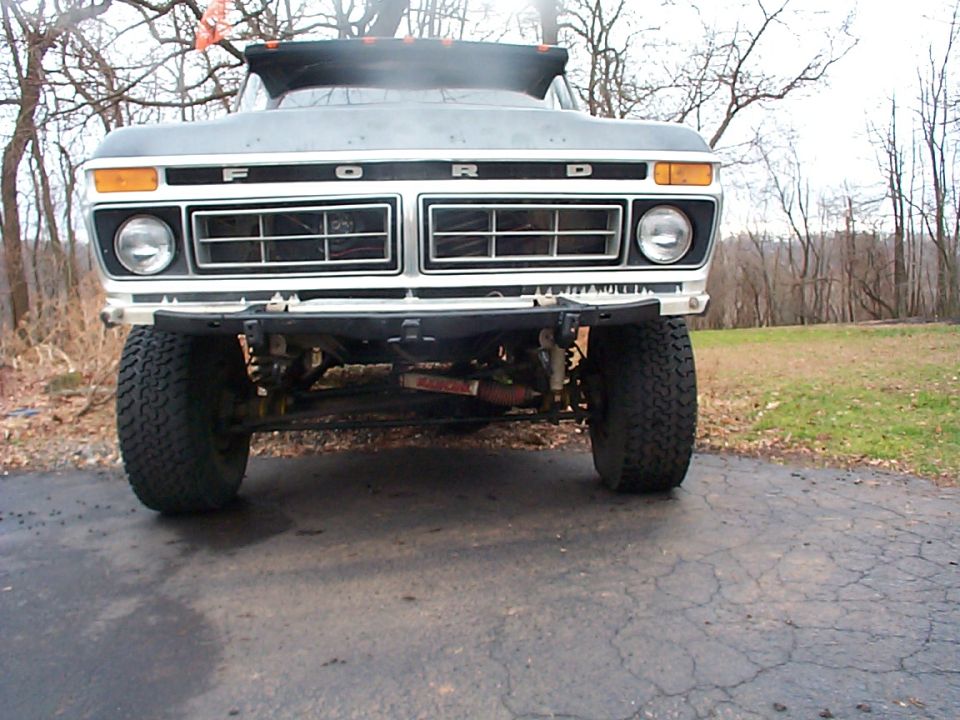 1979 Ford Bronco front grille with F O R D lettering, dual headlights, and large off-road tires