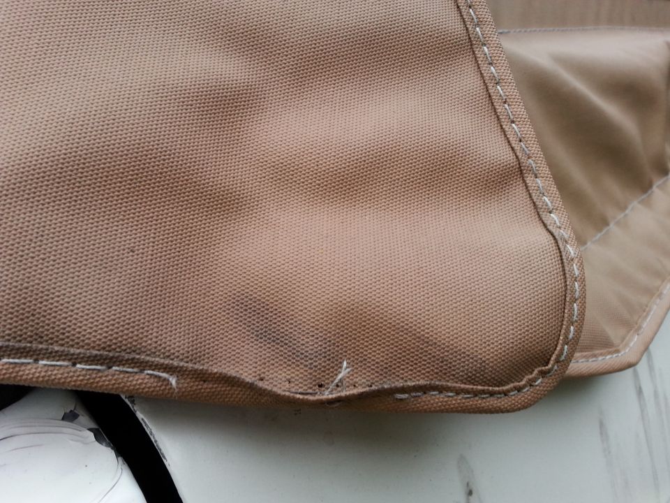 tan fabric with white stitching, part of a soft top cover. Supermotors.net logo visible