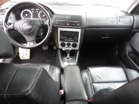 2002 Volkswagen Jetta - The dashboard and interior of a car are shown, leather seats and an Audi steering wheel emblem.