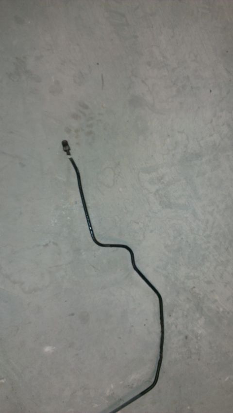 1996 Ford Bronco - A single brake line is shown against a concrete background, with a website watermark at the bottom.