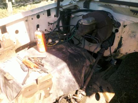1982 Ford Bronco - Tools and a can of spray cleaner are visible in the engine bay of a vehicle.