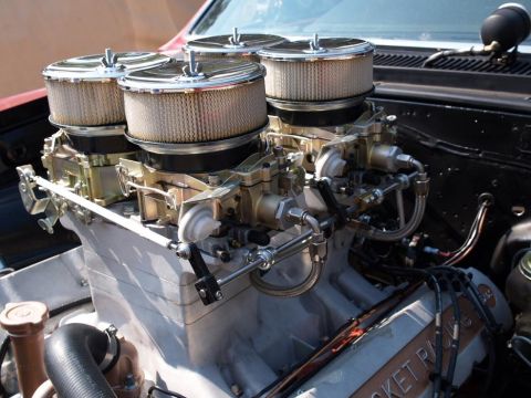 1972 Ford Ranchero - Close-up of a performance engine a triple carburetor setup with chrome air filters.