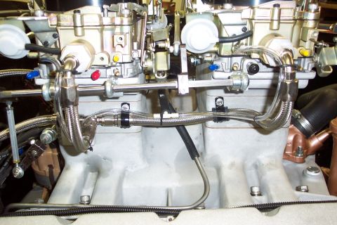 1972 Ford Ranchero - Close-up view of dual carburetors and associated fuel lines on an engine intake manifold.
