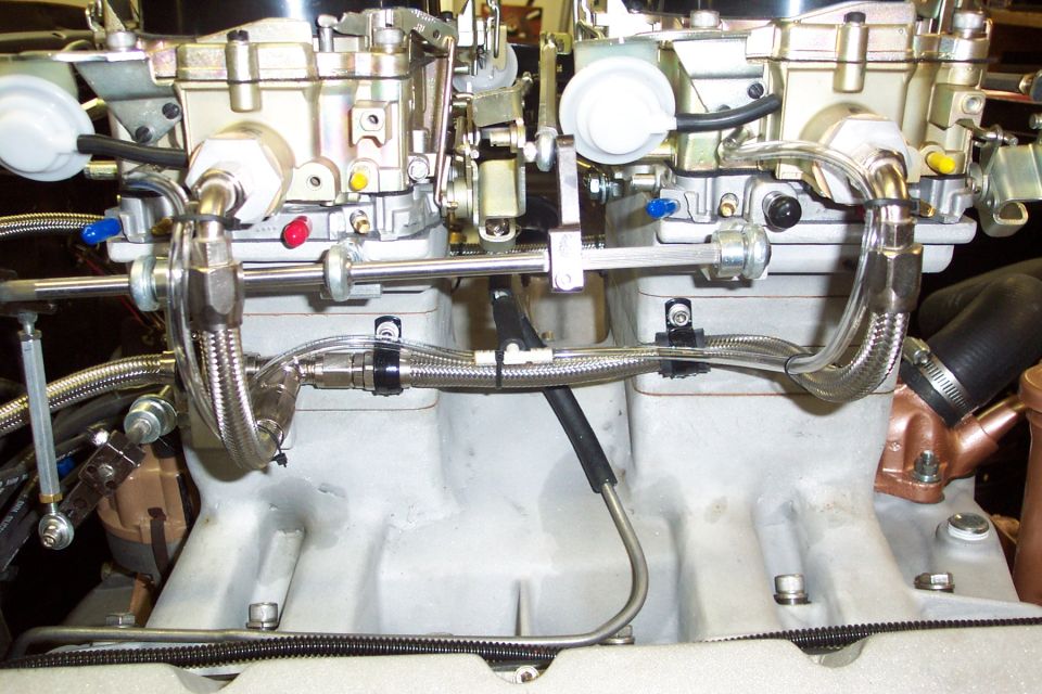 Dual carburetors with braided fuel lines and silver intake manifold