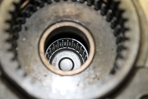 1995 Ford Bronco - Internal view of a vehicle's transfer case, showing gears and a roller bearing assembly.