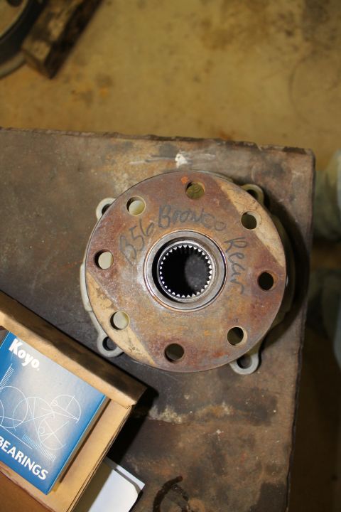 1995 Ford Bronco - Transfer case part marked '656 Bronco Rear' sits next to a box of Koyo bearings.