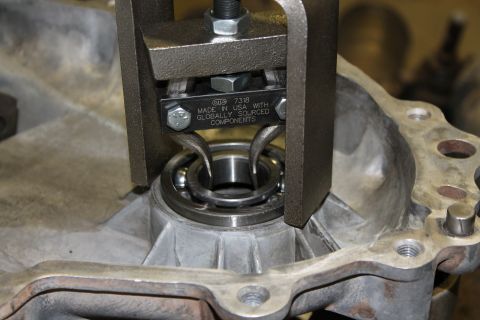 1995 Ford Bronco - A bearing puller tool is used to remove a bearing from a transfer case housing.