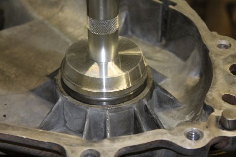 1995 Ford Bronco - Tool inserted into a transfer case housing, possibly for repair or assembly.