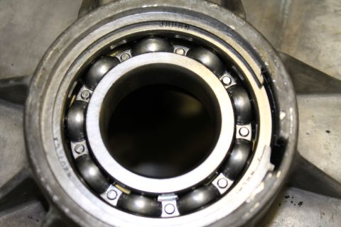 1995 Ford Bronco - A ball bearing, marked 'JAPAN', is shown installed in a metal component, likely part of a drivetrain.