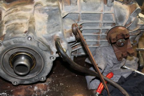 1995 Ford Bronco - Transfer case assembly with linkage and a wrench visible.