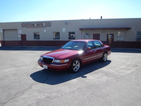 2002 Mercury Grand Marquis - This 2002 Mercury Grand Marquis is seen in a three-quarter front view, parked outside a business.