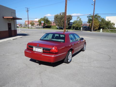 2002 Mercury Grand Marquis - This red 2002 Mercury Grand Marquis is viewed from the rear, showing its distinctive body style and a California license plate.