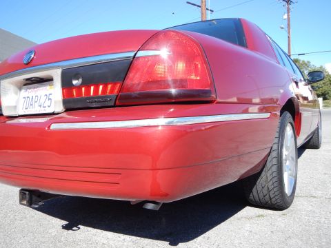 2002 Mercury Grand Marquis - Rear view of a red 2002 Mercury Grand Marquis showing the taillight and license plate.