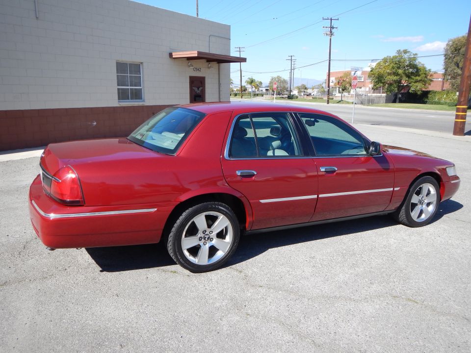 Red 2002 Mercury Grand Marquis sedan, rear 3/4 view, clean condition