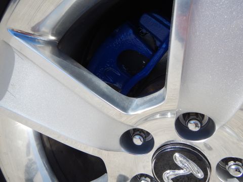 2002 Mercury Grand Marquis - A close-up shot focuses on a custom silver wheel and a vibrant blue brake caliper, with a Supermotors.net watermark visible.
